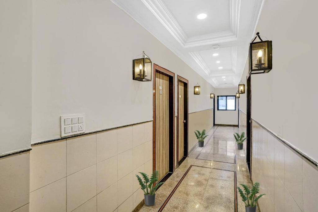 a hallway with potted plants in a building at Hotel O Chhaya in Aurangabad