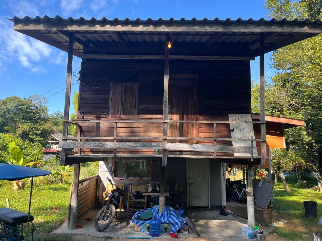 a tree house with a bike parked in front of it at Balance home happy in Ko Yao Noi