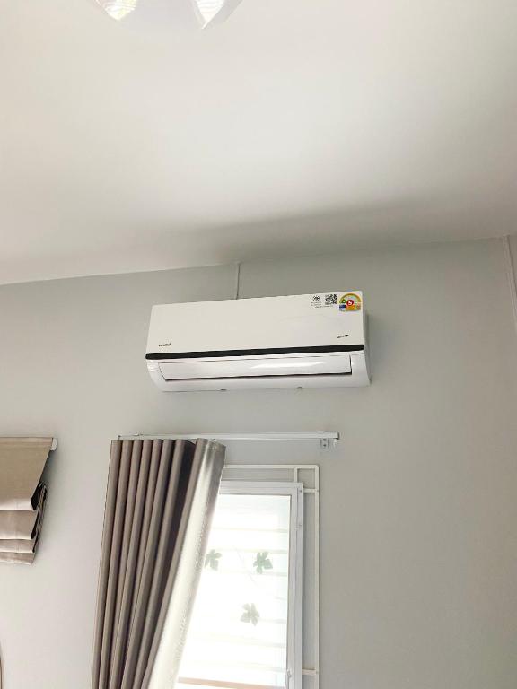 a air conditioner in a room with a window at Singgah Homestay Yala in Ban Sarong