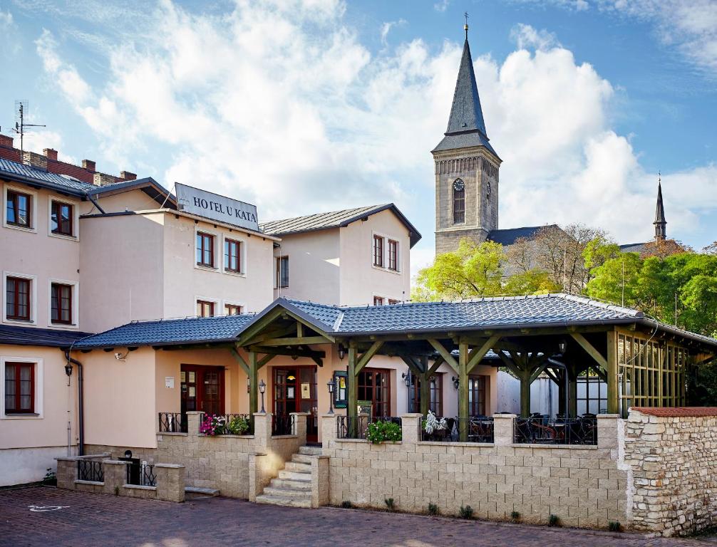 a building with a clock tower and a church at Hotel U Kata in Kutná Hora