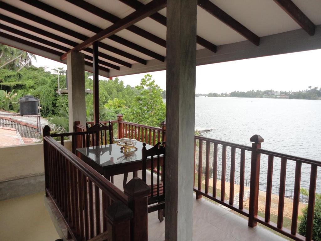 a porch with a view of the water at Sapara River Guest in Bentota