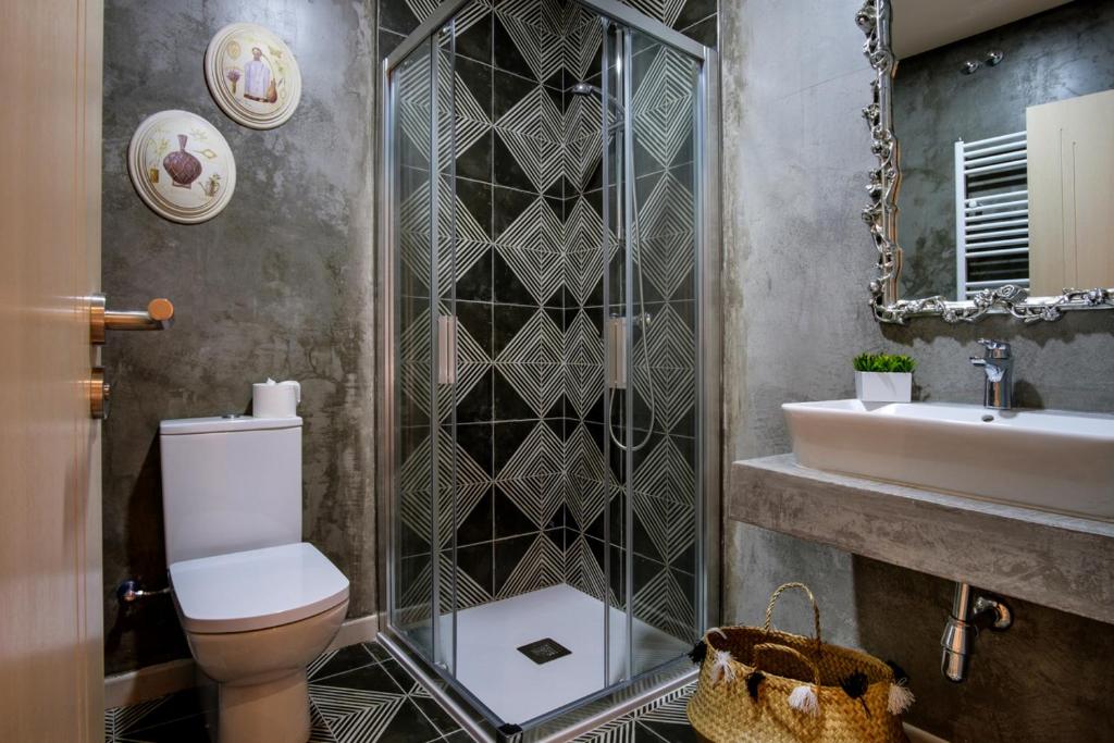 La salle de bains est pourvue de toilettes, d'un lavabo et d'un miroir. dans l'établissement La Casona de Nené, à Arzúa