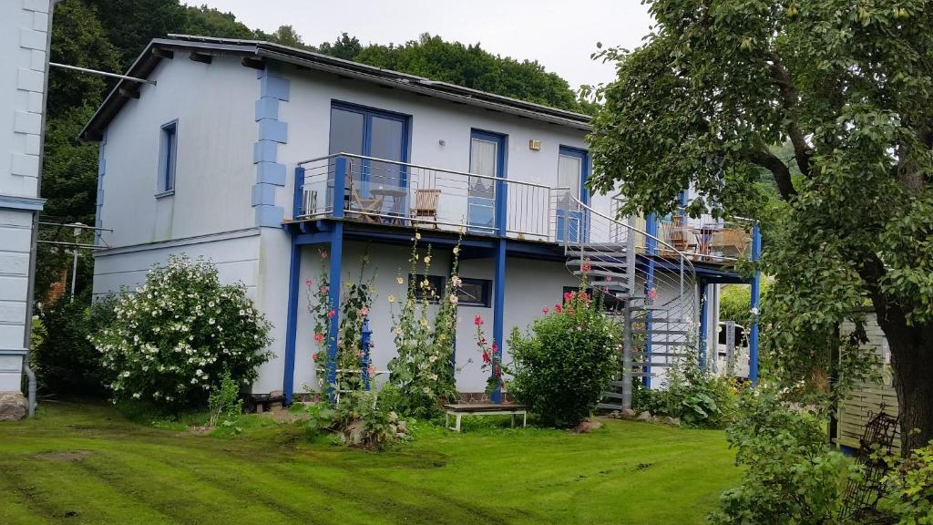 una casa azul y blanca con patio en Haus Britta Rügen, en Lietzow