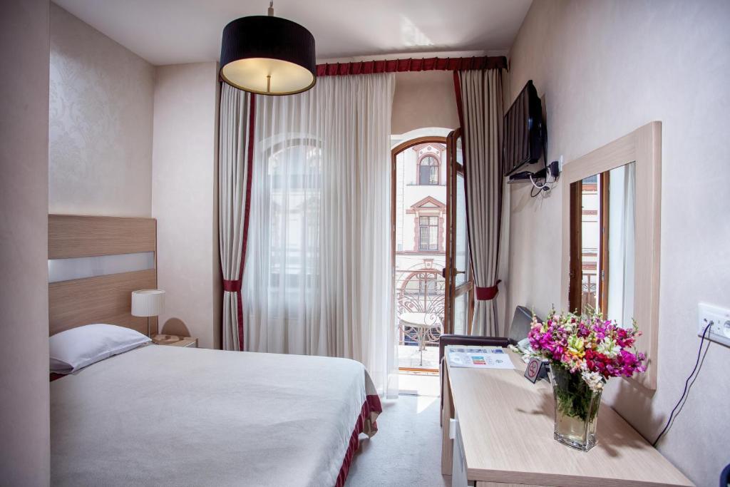 Postel nebo postele na pokoji v ubytování Boutique Hotel Palais Royal