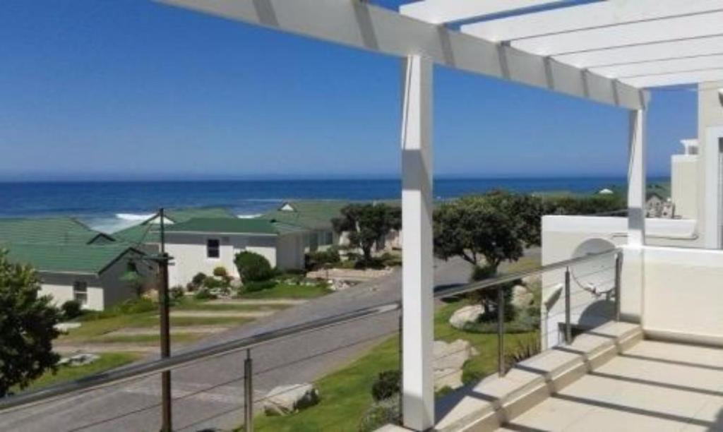 a balcony with a view of the ocean at Whale Rock 54 in Hermanus