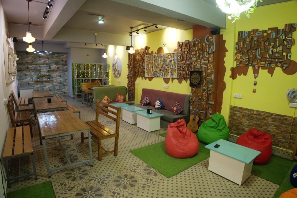 a room with a table and chairs and a table at Trippme Rishikesh, formerly The Sweven in Rishīkesh