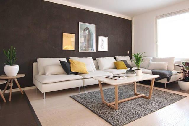 a living room with a white couch and a coffee table at 1 Bedroom Apartment in Maceira