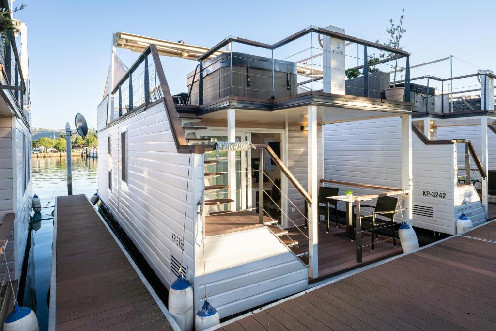 a house on a boat on the water at Lovely HouseBoat Apartment Portorose in Portorož