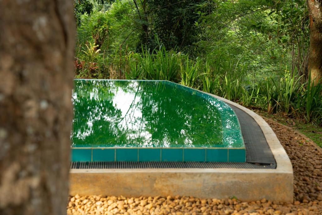 a fountain in the middle of a park at Evergreen Hideout by Tequila Holidays in Kandangama