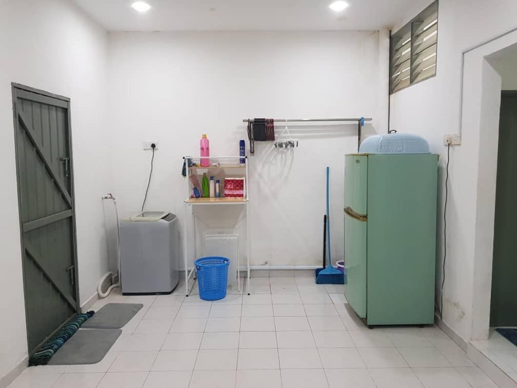 a kitchen with two refrigerators in a room at Alfateh Homestay in Sungai Petani