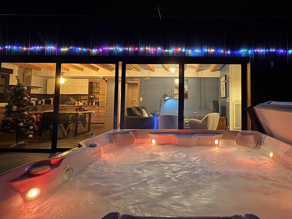 a jacuzzi tub in a living room with lights at Sweet Escape et Spa in Turckheim