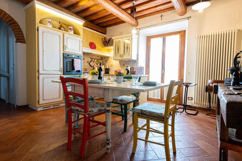 a kitchen with a table and chairs in a room at I Vigneti del Chianti in Barberino di Val dʼElsa