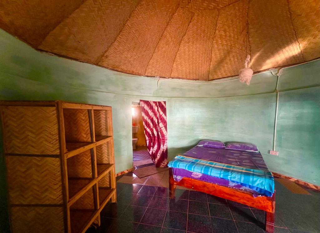 a small room with a bed in a tent at Doman Doman Eco Lodge in Gunjur