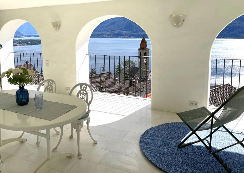 a dining room with a table and a view of the ocean at Il Nido by Fewotessin in Ronco s/Ascona - Porto Ronco