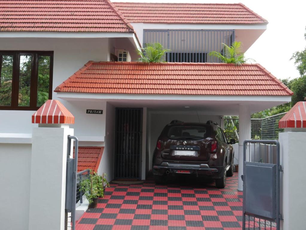a car parked in the garage of a house at Temple Courtyard in Chengannūr