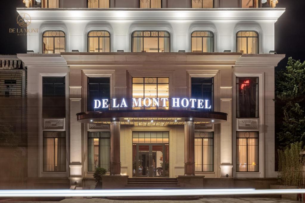 a building with a sign that reads de la mont hotel at De La Mont Hotel Ha Giang in Ha Giang