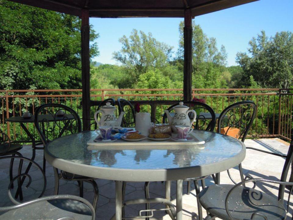 a table with a plate of food on a patio at B&B La Libellula in Pratella