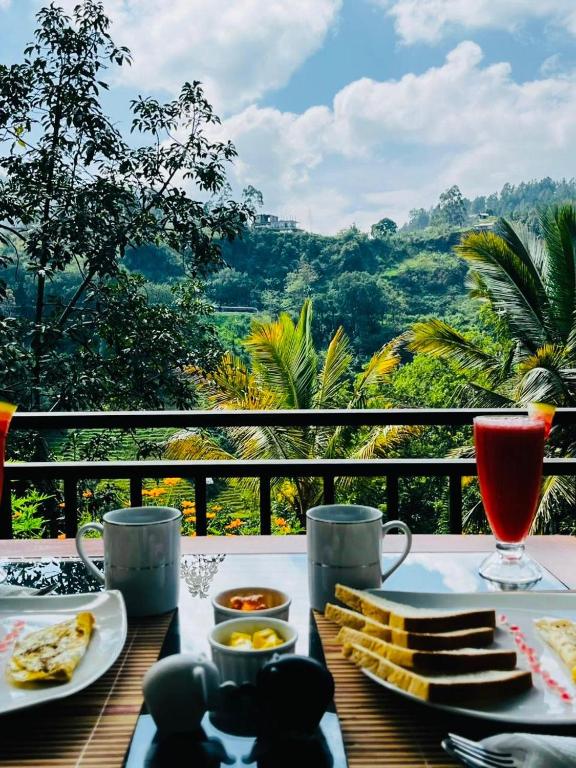 a table with food and drinks and a view of the mountains at The Aurelian in Ella