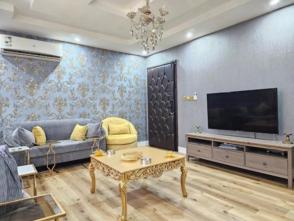 a living room with a couch and a tv at comfort suite in Jeddah