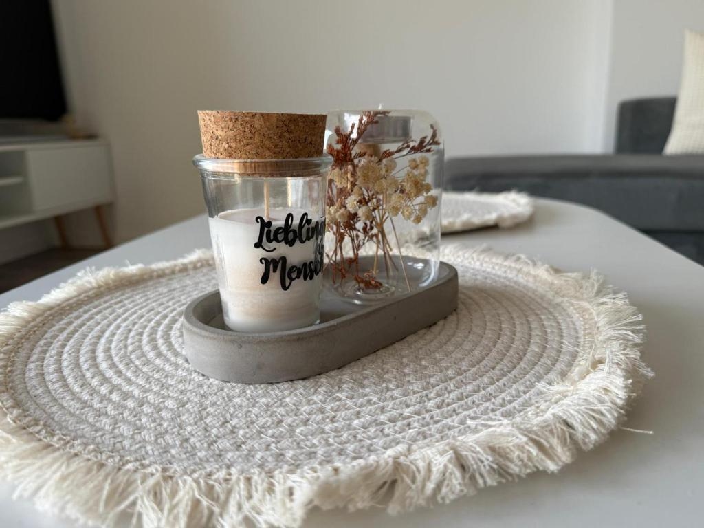 a table topped with a glass jar with a cork at Panorama trifft Gemütlichkeit in Nümbrecht