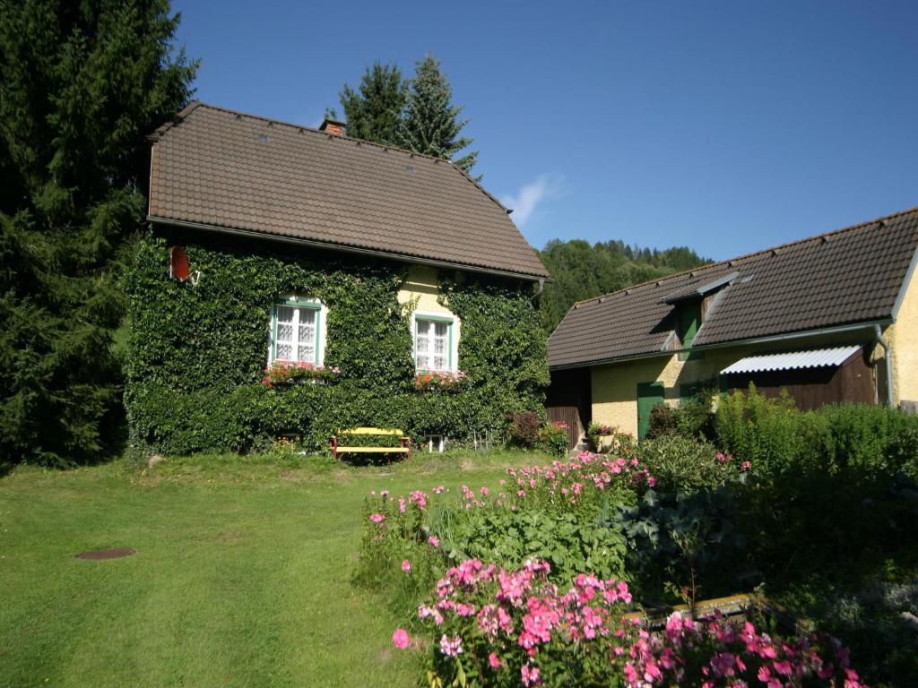 a house covered in ivy next to a garden at Ferienhaus in Scheifling nahe Skipisten in Scheifling