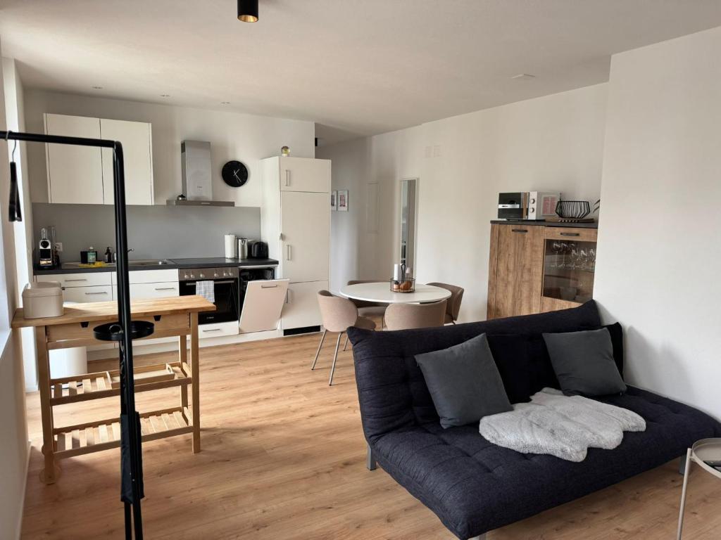 a living room with a couch and a kitchen at Alte Näherei in Degersheim