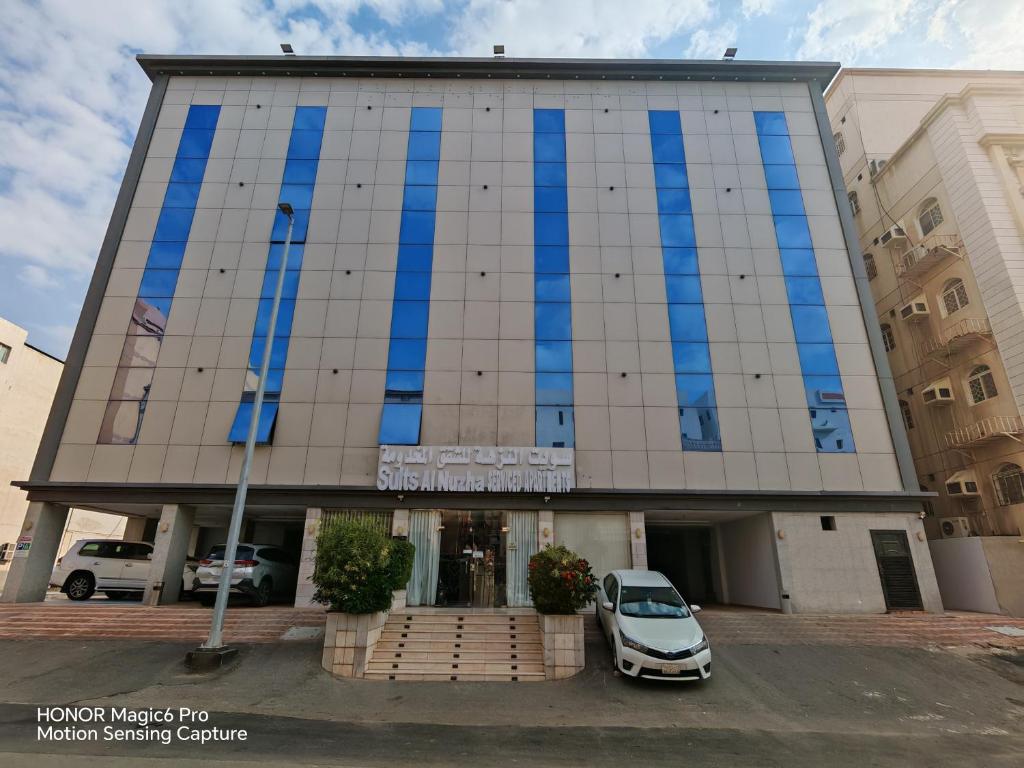 a car parked in front of a building at شقق سويت النزهة للشقق المخدومة اقتصادي in Jeddah