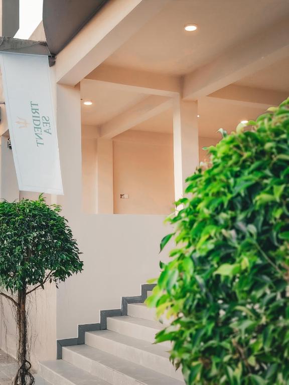 a staircase in a building with a green bush at Trident Sea Hotel in Negombo