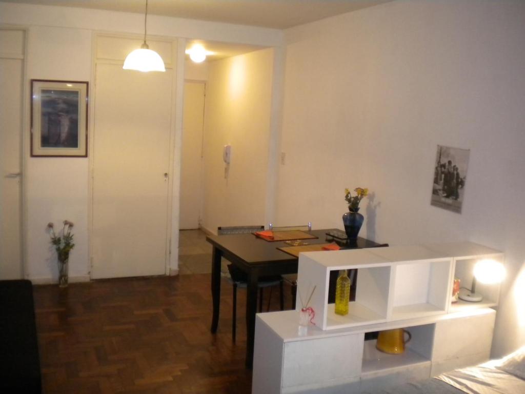 a living room with a table and a dining room at Recoleta Apartamento in Buenos Aires