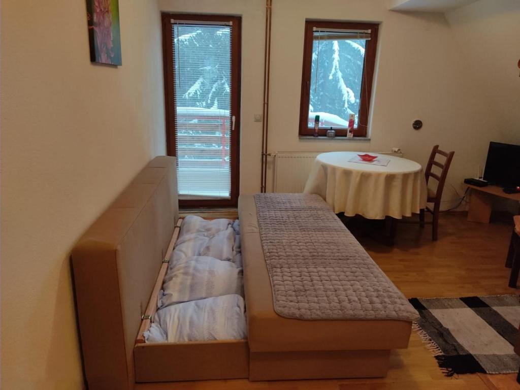 una sala de estar con un sofá y una mesa en Vikend kuća Libertas, en Šišava