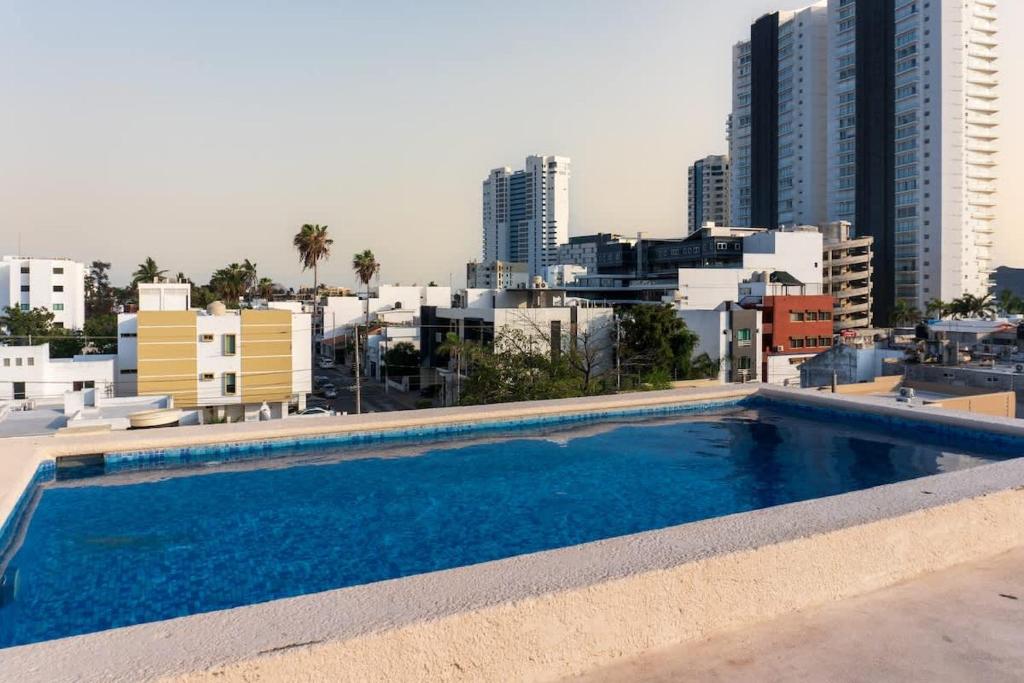 a swimming pool with a city in the background at Cozy apartment just two blocks from the beach in Isla Venados