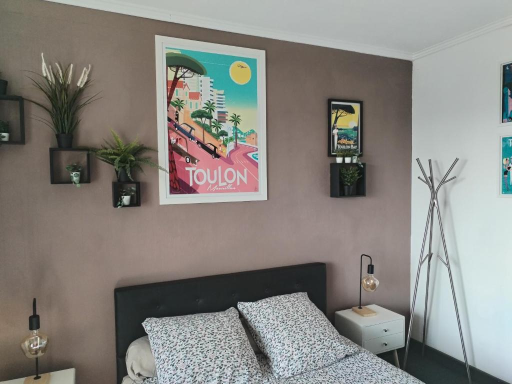 a bedroom with a bed and a poster on the wall at Le Côte d'Azur in Toulon
