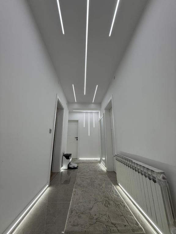 a hallway with white walls and a white ceiling at Luxury Apartmant Neptun Free Parking in Sarajevo