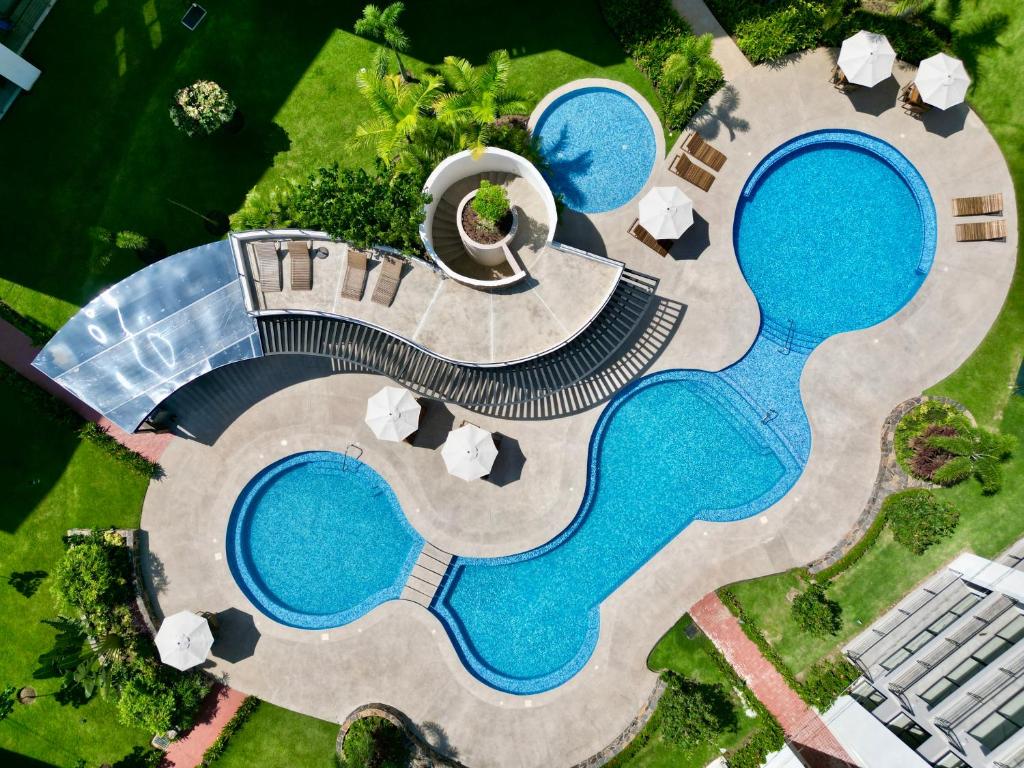 an overhead view of a pool with two swimming pools at Modern Luxury Residency at Altea-Sunset Pool View in Puerto Vallarta