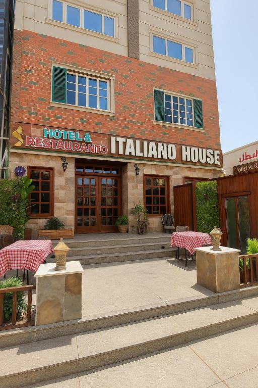 a building with tables and chairs in front of a building at البيت الايطالي - Italiano House in Baghdād