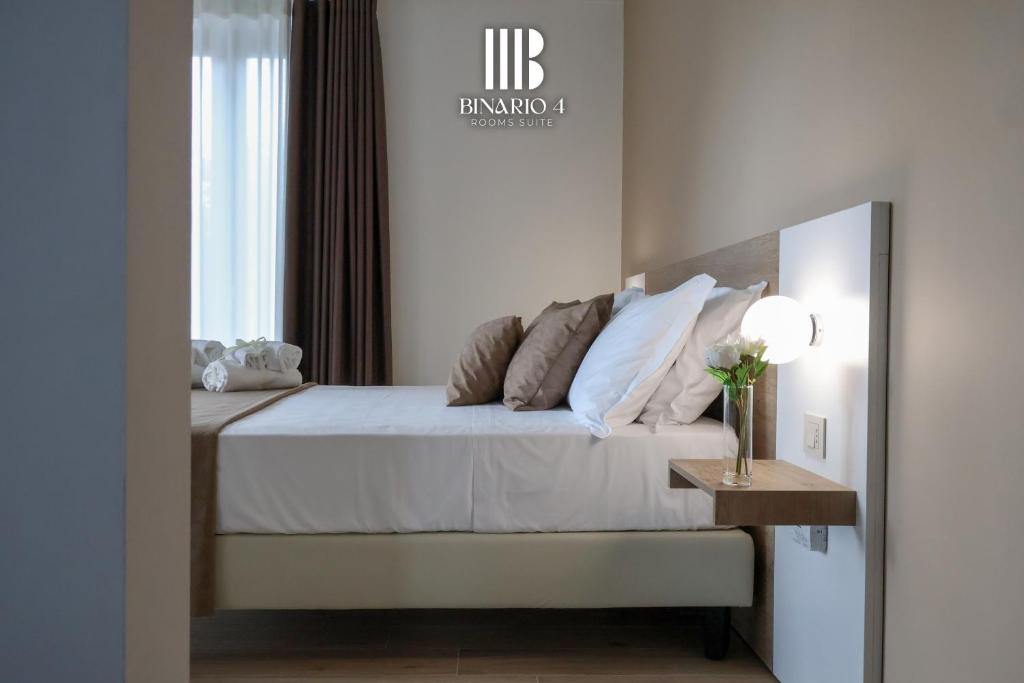 Ένα ή περισσότερα κρεβάτια σε δωμάτιο στο Binario 4 Rooms Suite