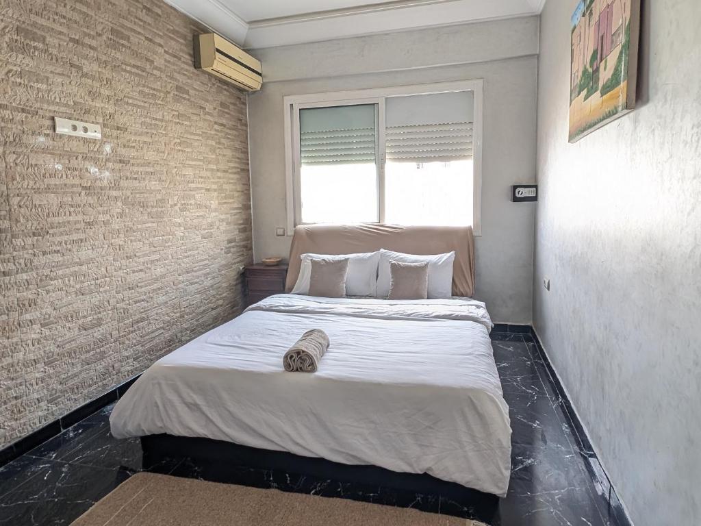 a large bed in a room with a window at Tayyurt Apartement city centre agadir in Agadir