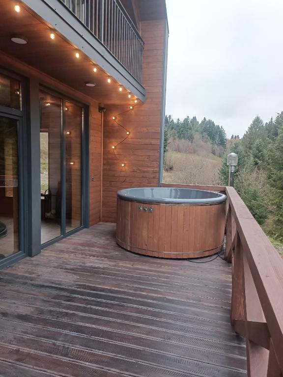 a hot tub on the deck of a house at Спас Резорт in Spas