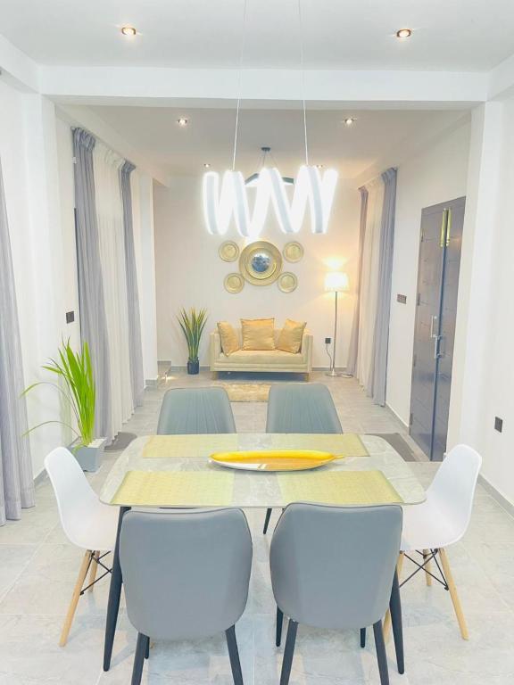 a dining room with a table and chairs and a couch at Villa EN 22 in Galle