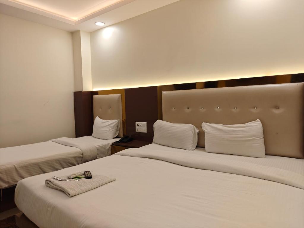 a hotel room with two beds with towels on them at Hotel The Grend Gauranga Just a min walk from New Delhi Railway Station - Paharganj in Jāmb