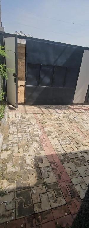 a building with a black wall and a door at Kaduna Laidos shortlet Appartment in Kaduna