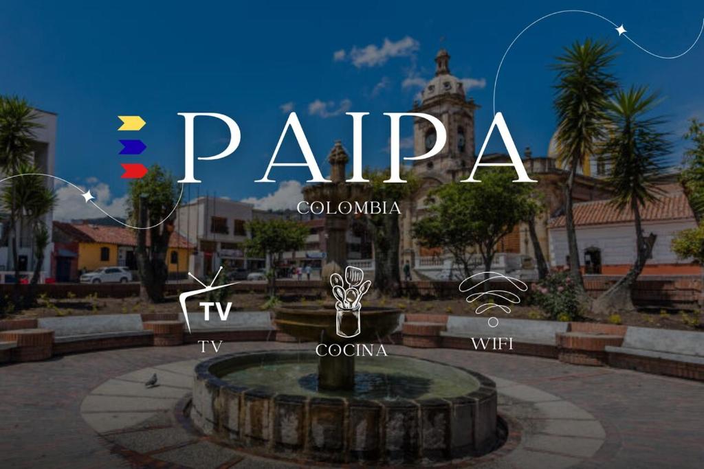 ein Schild für einen Park mit einem Brunnen in einer Stadt in der Unterkunft Cabaña Campestre Renacer in Paipa