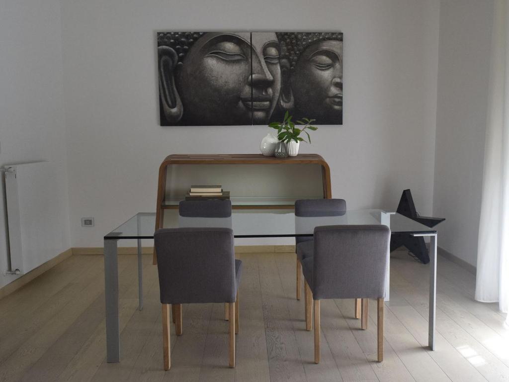a dining room table with chairs and a painting on the wall at My Loft in Naples in Naples