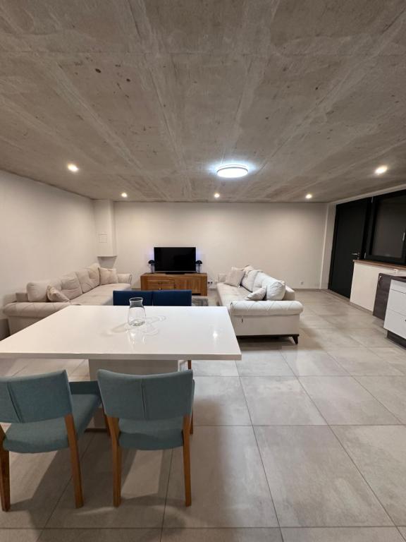 a living room with a white table and chairs at Innsbruck West in Inzing