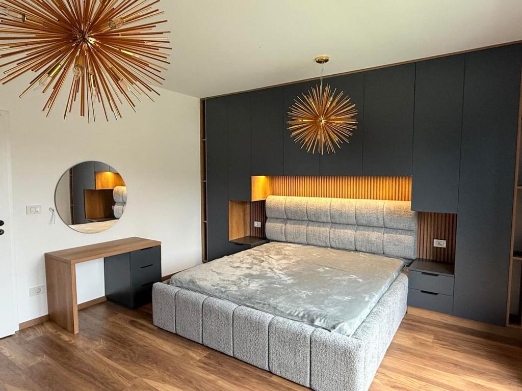 a bedroom with a large bed and a mirror at Villa Marina in Novoberdo