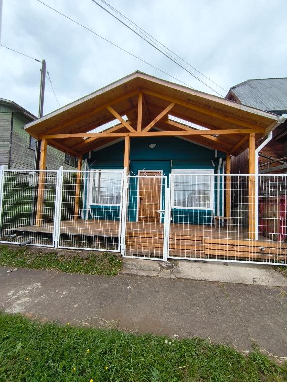 a house with a fence in front of it at Cabañas Sol y Luna Lago Ranco in Lago Ranco