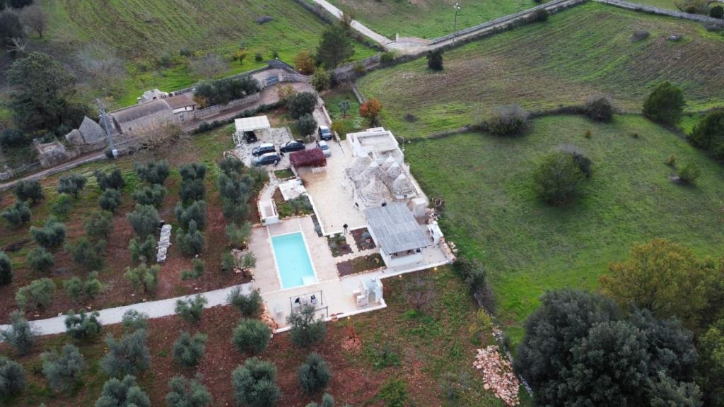 an aerial view of a house with a pool on a field at Luxury TrullidiGiulia, piscina uso esclusivo in Ostuni