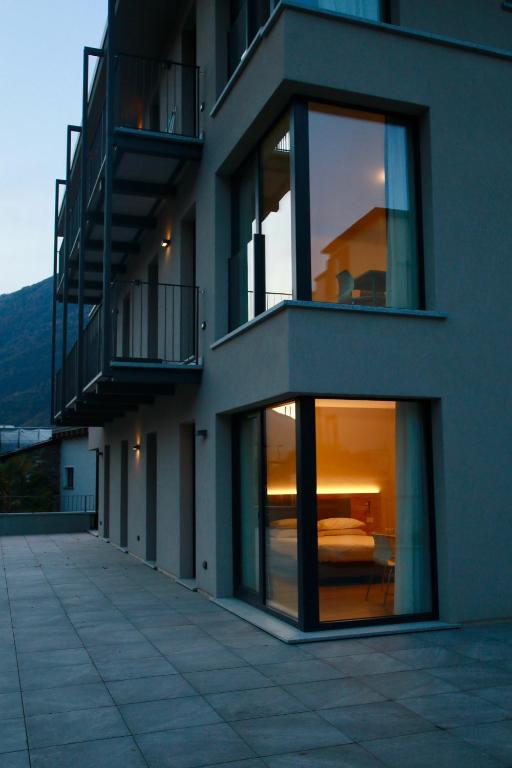 a building with a balcony and a bed in it at Bernina Suites - 150 metres to Bernina Express in Tirano