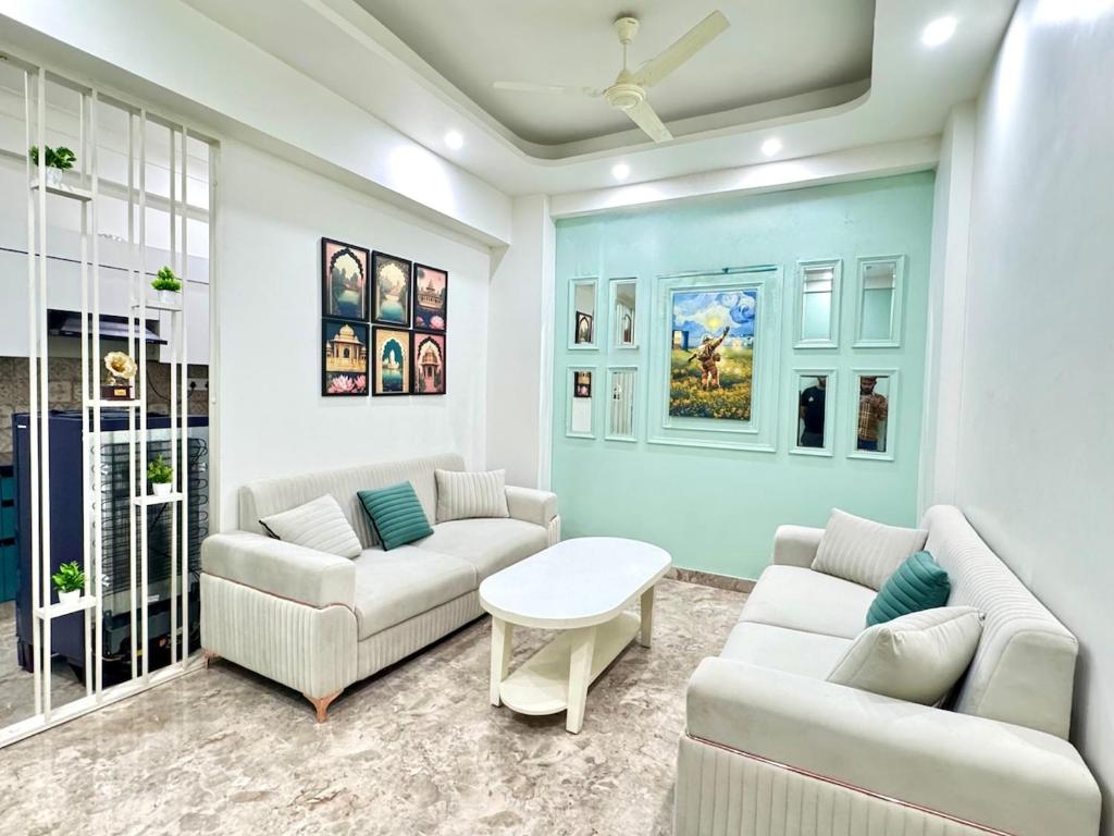 a living room with two couches and a table at The Olivia -Luxury Apartments in Rishīkesh