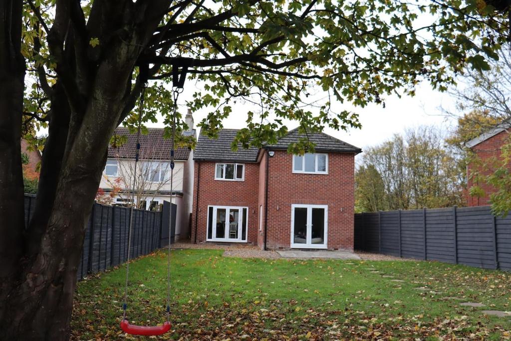 a red brick house with a black fence at Large 4 bedroom Family let, Contractor, Corporate in Market Harborough